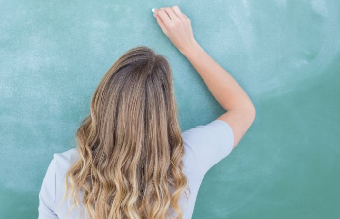 Teacher writing 10 Examples of Noun Sentences for Elementary Grammar